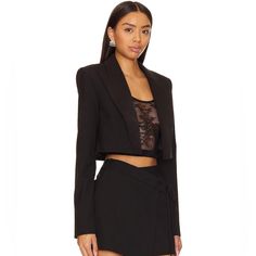 Power Up Your Business Chic Look With Nbd's Dante Cropped Blazer In Black. Featuring Padded Shoulders And Suiting Fabric, This Cropped Blazer Adds A Touch Of Sophistication. Complete The Ensemble With The Matching Trouser For A Powerful And Stylish Statement. Self: 68% Polyester 29% Viscose 3% Spandex Lining: 55% Polyester 45% Viscose Made In China Dry Clean Only Open Front Padded Shoulders Button Cuffs Midweight Suiting Fabric Model Measurement Model Is 5' 9'' And Is Wearing A Size Xs Waist 24' Sando Croptop, Business Chic, Suiting Fabric, Cropped Blazer, Black Blazer, Blazer Suit, Wide Leg Pants, Suit Jacket, Jackets & Coats