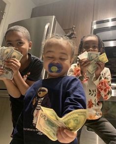 three children holding money in their hands and posing for the camera with one child's face painted