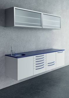 a white and blue bathroom sink sitting next to a wall mounted cabinet with two mirrors above it