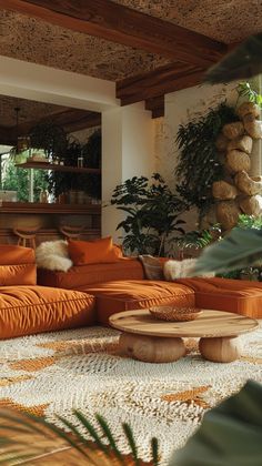 a living room filled with orange couches and lots of plants on top of it