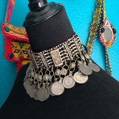 Beautiful Kuchi choker made from silver tone base metal with round coin medallions, seed beads, coins & fish motifs. An excellent addition to any belly dancing outfit. There are 2 metal loops on the back with black cords for wearing & it is lined with black cloth. This piece is in excellent condition. Handmade Medallion Coin Necklace For Festivals, Adjustable Medallion Jewelry For Festivals, Festival Coin Pendant Necklace In Medallion Shape, Handmade Adjustable Coin Necklace For Festivals, Adjustable Metal Coin Necklace, Bohemian Adjustable Choker For Festivals, Bohemian Coin Pendant Necklace For Festivals, Silver Bohemian Choker For Ceremonial Occasions, Silver Coin Necklace For Festival