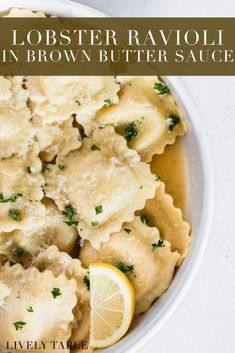 a white bowl filled with dumplings and lemon slices