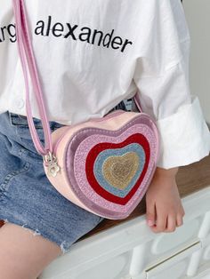 Introduce your child to style with our Sparkly Heart Shaped Mini Crossbody Bag. Crafted from synthetic leather, this trendy bag features a colorful color block design that is sure to make a statement. Perfectly sized for kids, your little one can carry their essentials with ease while adding a touch of sparkle to their outfit. Cute Bags With Zipper Closure, Playful Multicolor Crossbody Bag, Playful Multicolor Shoulder Bag As Gift, Playful Multicolor Shoulder Bag Gift, Fun Multicolor Crossbody Shoulder Bag, Playful Multicolor Shoulder Bag For School, Cute Multicolor Crossbody Shoulder Bag, Multicolor Bags With Adjustable Strap For Playtime, Playful Multicolor Bags With Zipper Closure