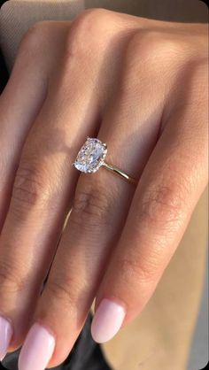 a woman's hand with a diamond ring on it