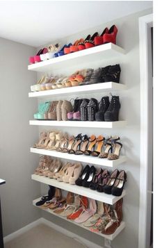 a white shelf filled with lots of shoes