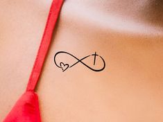 a woman's stomach with an infinite love tattoo on her left side and a heart in the middle