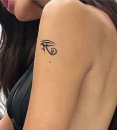 a woman's arm with an eye tattoo on the left side of her arm