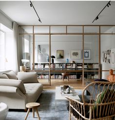 a living room filled with furniture and bookshelves