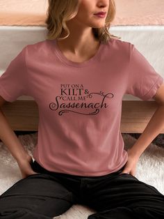 "\"Put on a kilt and call me sassenach.\" Said every Outlander fan ever. You'll draw in all your fellow JAMMF fans with this shirt. Then you can all get swoony together. Know an Outlander fangirl (or fanboy, we don't judge) who'd love this t-shirt? Yeah, so do we! That's why we made this one. Perfect girlfriend gift idea. Details: This classic unisex jersey short sleeve tee fits like a well-loved favorite. Soft cotton and quality print make users fall in love with it over and over again. These t Outlander T Shirts, Perfect Girlfriend, Claire Fraser, Outlander Fan, Jamie Fraser, Don't Judge, Girlfriend Gift, Kilt, Leisure Wear