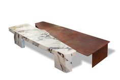 a marble and metal bench sitting on top of a white floor next to a wooden table