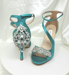 Teal Bridal Shoes with sparkling crystal applique in the front and sparkling back design. The heel height is approximately 3.5 inches (outside measurement as shown in the picture above). I believe these shoes run about 1/2 bigger than normal so I suggest ordering a 1/2 size down from your normal heel size. Please contact me with any questions you may have! Please visit my website for additional bridal products. http://www.abiddabling.com IMPORTANT ALL SIZES ARE IN U.S. SIZES - PLEASE CONTACT ME Turquoise Heels Wedding, Silver Heels With Rhinestones For Reception, Bedazzled High Heel Wedding Heels, Bedazzled High Heels For Wedding, Fitted Rhinestone Wedding Heels, Glamorous Rhinestone Wedding Shoes For Reception, Ankle Strap Wedding Shoes With Rhinestones, Embellished Fitted Wedding Shoes With Closed Toe, Crystal Embellished Heels For Wedding Reception