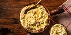 a wooden bowl filled with mashed potatoes and meat