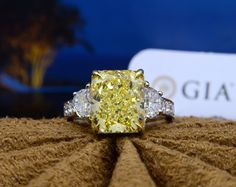 This extravagant diamond ring is created with a gleaming 4.00 Ct. radiant cut fancy light yellow diamond center stone elaborately framed by 1.25 Ct. Round cut diamonds. This one of a kind fancy yellow Natural diamond is certified by GIA, the world’s most reliable diamond laboratory in the diamond industry. Metal : 14K Gold, 18K Gold, Platinum/18KY Setting Type : Pave Total Carat : 5.25 Carats Type : Natural Diamond Shape : Radiant Cut Carat Weight : 4.00 Ct.(GIA Certified) GIA Certificate : Incl Elegant Yellow Emerald Cut Diamond Ring, Elegant Yellow Emerald-cut Diamond Ring, Yellow Radiant Cut Diamond Ring With Accents, Yellow Diamond Ring With Radiant Cut And Diamond Accents, Yellow Diamond Ring With Radiant Cut And Accents, Gia Certified Yellow Diamond Wedding Ring, Yellow Gia Certified Diamond Wedding Ring, Yellow Gia Certified Diamond Ring For Wedding, Yellow Diamond Ring With Emerald Cut