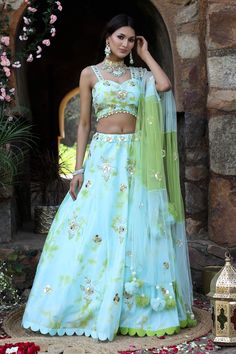 Aqua blue, green attached cancan tie and dye lehenga with floral embroidery detailing. Comes with embroidered padded blouse and dupatta.
Components: 3
Pattern: Dye and Embroidery
Type Of Work: Tie and Dye; Mirror, Nakshi, Beads, Cut-dana, Sequins, Zari Embroidery
Neckline: Sweetheart
Sleeve Type: Sleeveless
Fabric: Uppada Silk, Net
Color: Blue,Green
Other Details: 
Attached lining
Approx Weight: (in kgs) : 4 to 5
Occasion: Mehendi and Haldi - Aza Fashions Designer Green Lehenga With Floral Embroidery, Green Tissue Silk Sets With Floral Embroidery, Green Floral Embroidered Tissue Silk Sets, Green Floral Embroidery Tissue Silk Sets, Green Organza Choli With Floral Embroidery, Festive Green Lehenga With Floral Embroidery, Green Organza Sharara With Floral Embroidery, Green Lehenga With Floral Embroidery For Navratri, Green Embroidered Organza Choli