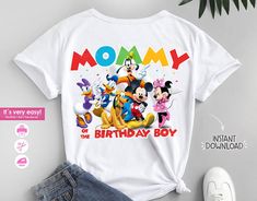 a white shirt with mickey mouse and friends on it