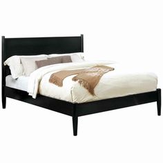 a black bed frame with white sheets and pillows on it's headboard, in front of a white background