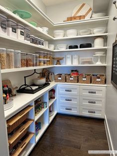 an organized pantry with white cabinets and drawers