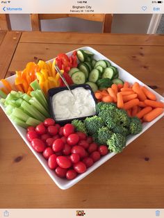 a platter filled with veggies and dip