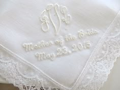 a wedding handkerchief with the word mother of the bride written on it and a lace border