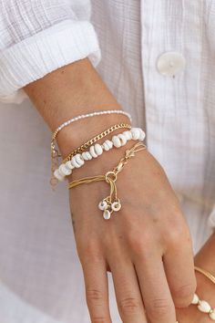 Three tiny natural puka shells dangle from this dainty gold-filled bracelet. This gold multi strand beauty embodies the laid-back energies of Hawaii. ✦ DETAILS ✦ ✧ Name: Kaihohonu - (KAEE ho HO noo) - deep sea, high tide. ✧ One size fits most. ✧ 18kt gold filled with lobster clasp. ✧ Natural puka shells. ✧ All Ke Aloha Jewelry pieces come packaged thoughtfully, beautifully, and ready for gift giving. ✦ MORE GOLD BRACELETS ➤ https://www.etsy.com/shop/kealohajewelry/?section_id=11533635 ✦ Sign up Dainty Adjustable Chain Bracelet For Beach, Dainty Adjustable Bracelet For Beach, Dainty Adjustable Beach Bracelet, Dainty Bracelet With Adjustable Chain, White Bohemian Bracelet With Adjustable Chain, Charm Bracelet Gold, Hawaii Jewelry, Layered Chain, Bracelets Design