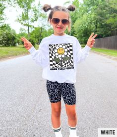 Our retro smiley face graphic sweatshirt features a vintage inspired daisy flower happy face checkered design. Our crewneck pairs perfectly with other matching size and style variations (linked below). ✩ ✩ 𝗧𝗼𝗱𝗱𝗹𝗲𝗿 𝗕𝗲𝗹𝗹𝗮 𝗖𝗮𝗻𝘃𝗮𝘀 𝗧𝗲𝗲: ✩ 𝗞𝗶𝗱𝘀 𝗕𝗲𝗹𝗹𝗮 𝗖𝗮𝗻𝘃𝗮𝘀 𝗧𝗲𝗲: ✩ 𝗞𝗶𝗱𝘀 𝗖𝗼𝗺𝗳𝗼𝗿𝘁 𝗖𝗼𝗹𝗼𝗿𝘀 𝗧𝗲𝗲: https://starrieapparel.etsy.com/listing/1767771965 ✩ 𝗞𝗶𝗱𝘀 𝗦𝘄𝗲𝗮𝘁𝘀𝗵𝗶𝗿𝘁: https://starrieapparel.etsy.com/listing/1753563776 ✩ 𝗔𝗱𝘂𝗹𝘁 𝗕𝗲𝗹𝗹𝗮 𝗖𝗮𝗻𝘃𝗮𝘀 𝗧𝗲𝗲: https://starrieapparel.etsy.com/listing/1753560266 ✩ 𝗔𝗱𝘂𝗹𝘁 𝗖𝗼𝗺𝗳𝗼𝗿𝘁 𝗖𝗼𝗹𝗼𝗿𝘀 𝗧𝗲𝗲: https://starrieapparel.etsy.com/listing/1753601114 ✩ 𝗔𝗱𝘂𝗹𝘁 𝗦𝘄𝗲𝗮𝘁𝘀𝗵𝗶𝗿𝘁: https://starrieapparel.etsy.com/listing/1767759139 Kids Smiley Face Sweatshirt, Girls Daisy Long Sleeve Smiley Face Top For Fall, Playful Smiley Face Tops For Spring, Cute Long Sleeve Smiley Face Top, Trendy Long Sleeve Tops With Smiley Face, Smiley Face Sweatshirt, Checker Design, Face Graphic, Checkered Design, Graphic Sweaters