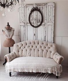 a white couch sitting in front of a wooden door