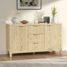 a wooden cabinet with two drawers and a lamp next to it on top of a hard wood floor