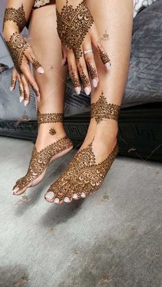 a woman with henna on her legs and feet