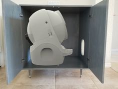 an odd looking toilet sitting in a cabinet