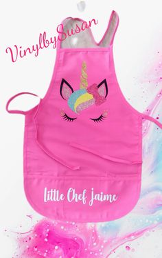 a pink apron with a unicorn face on it