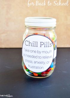 a jar filled with colorful candy on top of a table