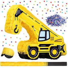 a yellow construction vehicle next to a pencil and confetti