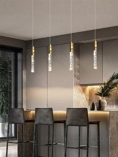 modern kitchen with bar stools and pendant lights