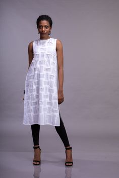 White organic cotton sleeveless woman's top with crew neck, side slits and textured front. We can make the texture All round instead of only the front. Do DM us for more information to customise. Geometric folds are created on fabric using the shadow folding technique, which is made from a single three step process. Every Fold adds a unique intricacy, and gives it a dimensionality which is not present on a flat surface, thus creating a breathtaking piece of textile art. This garment is inspired White Sleeveless Cotton Kurta, Sleeveless White Kurta For Spring, Spring Sleeveless Tunic, Fitted Sleeveless Kurta For Spring, Spring Fitted Sleeveless Kurta, Summer Fitted Straight Kurta Tunic, Fitted Straight Kurta Tunic For Summer, Summer Cotton Straight Kurta Tunic, Sleeveless Cotton Kurta For Summer