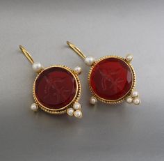 Description Gemstone - Red Glass Material - Brass Gemstone Size - 18 mm Earring Height Including Hoop - 4 cm Earring Width - 2 cm Finish - Smooth and high polished with Little Oxide Antique Look. Note -The earrings are made to order, production day is about 3-5 working days. The one you receive may be slight different from the one in the picture due to handmade nature, but it will be almost same as in the above picture.These pieces are handcrafted from start to finish and have an imperfect handmade look.These earrings are the perfect addition to your collection. Our rings are meant to be classic enough for everyday wear or to give as a bridesmaid gift. You will receive the same piece as in the picture or identical. Since all gemstones are different from each other, I cannot guarantee that Red Pierced Earrings For Wedding, Red Pierced Earrings For Formal Occasions, Red Formal Pierced Earrings, Formal Red Pierced Earrings, Red Round Earrings For Anniversary, Round Clip-on Jewelry As Gift, Red Pierced Earrings For Anniversary, Cabochon Pearl Drop Earrings For Gift, Formal Red Pearl Earrings With Matching Set