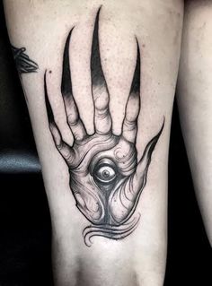 a black and white image of a hand with horns on it's arm, which has an eye in the middle