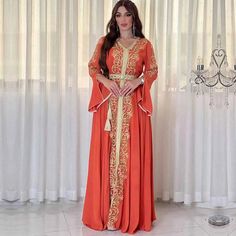 Orange Long Sleeve Dress For Eid, Bohemian Orange Dresses For Eid, Long Orange Dress For Festive Occasion, Long Orange Dresses For Festive Occasions, Festive Long Orange Dress, Orange Floor-length Dress For Eid, Elegant Orange Spring Kaftan, Orange Long Sleeve Dress With Floral Embroidery, Embroidered Orange Floor-length Dress