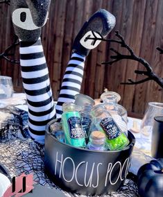 a table topped with halloween decorations and bottles