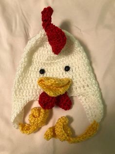 a crocheted hat with a chicken on it