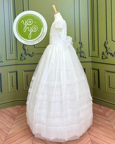 A classical and traditional white communion gown for girls made with a lightweight optic white organza. It has beautiful and delicate pleats throughout and has buttons and a bow on the back for closure. Made in Spain Does not include crinoline Lining: 100% cotton Dry clean Final Sale, no exchanges nor returns will be accepted White Tulle First Communion Dress With Ruffles, Fitted Tulle First Communion Dress With Ruffles, Organza First Communion Dress With Ruffles, First Communion Gown With Ruffles And Fitted Bodice, First Communion Gown With Fitted Bodice And Ruffles, Fitted Tulle First Communion Dress For Confirmation, Fitted Tulle First Communion Dress, White Ruffled Gown For Confirmation, First Communion Dress With Ruffles And Fitted Bodice