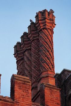 the top of a brick building with a spiral design on it