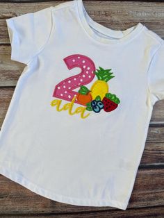 Celebrate your little one's birthday in style with this adorable Twotti Frutti Birthday Shirt! This shirt features a fun, colorful fruit-themed appliqué and embroidery design that's perfect for a summer birthday or fruity party theme. Made from high-quality, soft cotton, this personalized birthday tee ensures comfort while looking picture-perfect for your toddler's big day. I can change up the shirt, fabric and/or thread colors to match your theme. Everything on this shirt can be customized to your specifications! Don't see the size you need??  Just message me!  I can typically get Youth sizes I just don't usually carry them on hand.  In the notes section at checkout Please leave your child's name if personalizing, and child's BIRTHDAY NUMBER, thread colors if changing and if you are inter Embroidered Cotton Top For Birthday, Pink Birthday Shirt For Summer, Pink Summer Birthday Shirt, Embroidered Crew Neck Birthday T-shirt, Embroidered Crew Neck T-shirt For Birthday, White Embroidered T-shirt For Birthday, Embroidered Crew Neck Top For Birthday, White Embroidered Tops For Birthday, Playful Summer Birthday Shirt