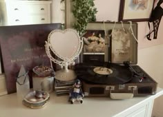 there is a record player and other items on the table