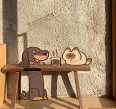 a dog sitting at a table with a cup of coffee in front of it, next to a cat