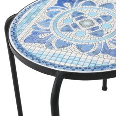 a blue and white mosaic table sitting on top of a metal stand