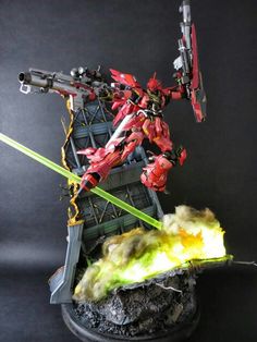 an action figure is shown on top of a pile of rubble and fire with two swords