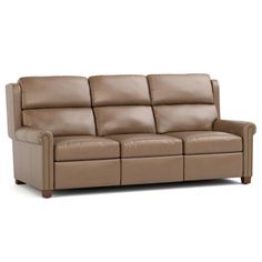 a brown leather couch sitting on top of a white floor