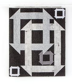 a black and white quilt with the letter e in it's center surrounded by smaller squares