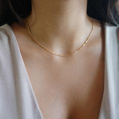 Gold Dainty Sparkle Chain Delicate Thread Chain Minimalist Layering Choker Tiny Chain Necklace Jewelry Gift for Women The perfect add-on to any wardrobe. Shiny and dainty, for either a casual or more elegant style. Great to combine with other pieces from our shop for a layered look. Delicate chain gold plated / rhodium plated over stainless steel. Very thin and delicate 1.5mm, with flattened beads sparkling like little mirrors. Sturdy and high quality. Minimalist Necklace Layering, Decent Gold Jewellery, Small Gold Chain For Women, Minimalist Chain Necklace, Good Chains Women, Small Dainty Jewelry, Modern Gold Chain Designs For Women, Simple Chains For Daily Use, Dainty Gold Choker