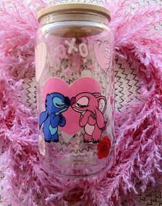 a glass jar with an image of a blue cat and pink heart on the lid